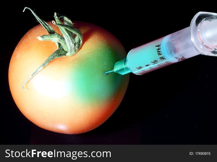 A single tomato with drops isolated