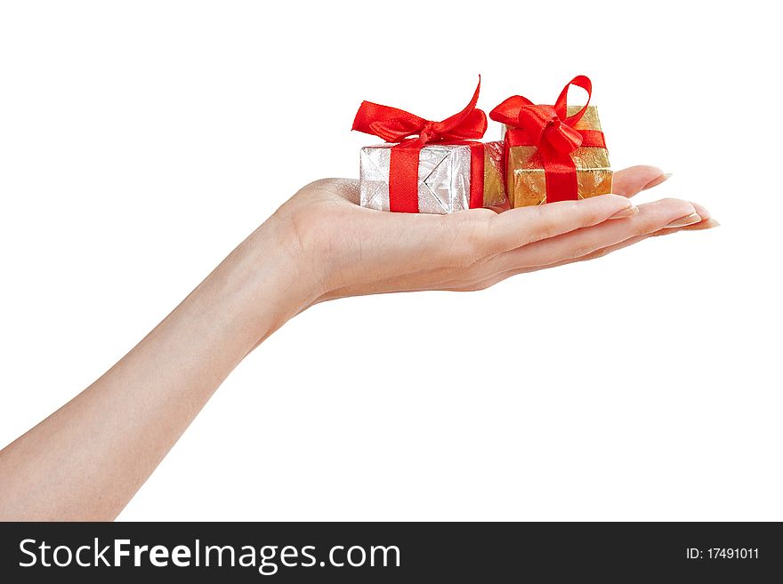 Golden and siver gift boxes with red bows in the hand. Golden and siver gift boxes with red bows in the hand