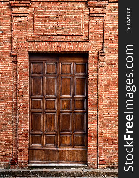 Antique tuscan door in Pienza, Italy.