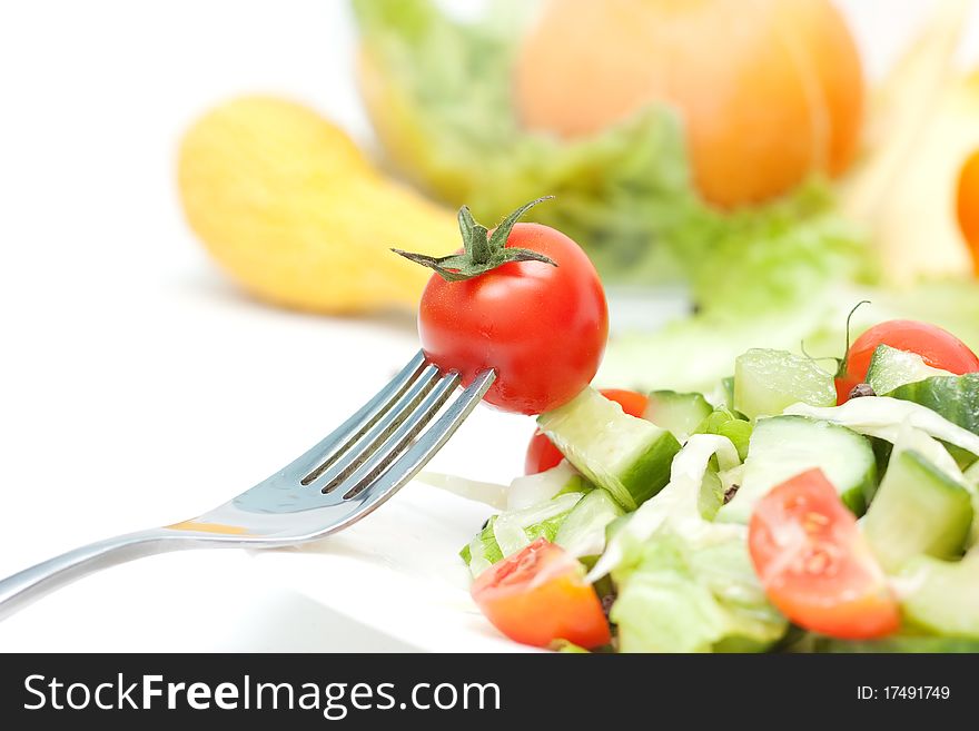 Tomato cherry and fork on white background. Tomato cherry and fork on white background.