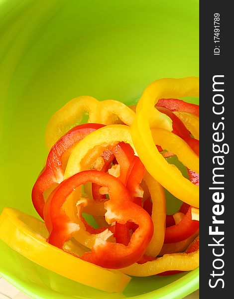 Sliced sweet peppers on bright green background