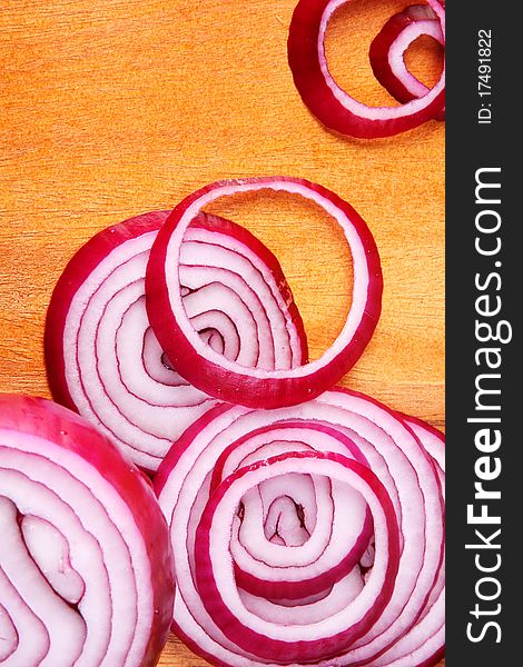 Red onion on wooden hard board