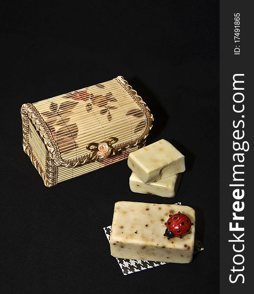 Organic soaps and jewelry box on dark background. Organic soaps and jewelry box on dark background