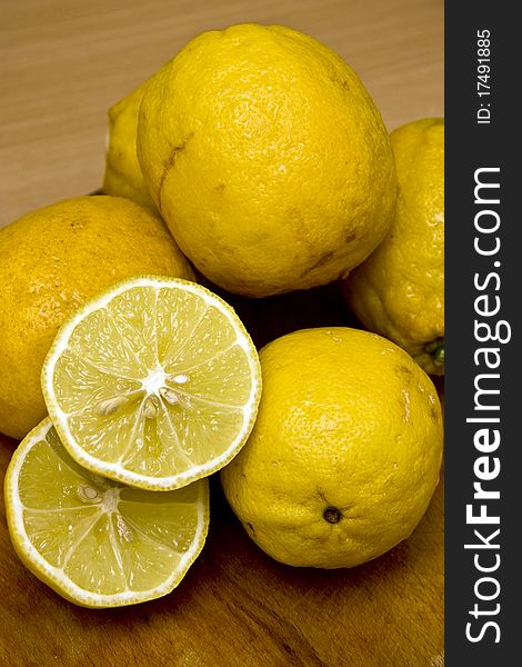 Fresh organic lemons on wooden background