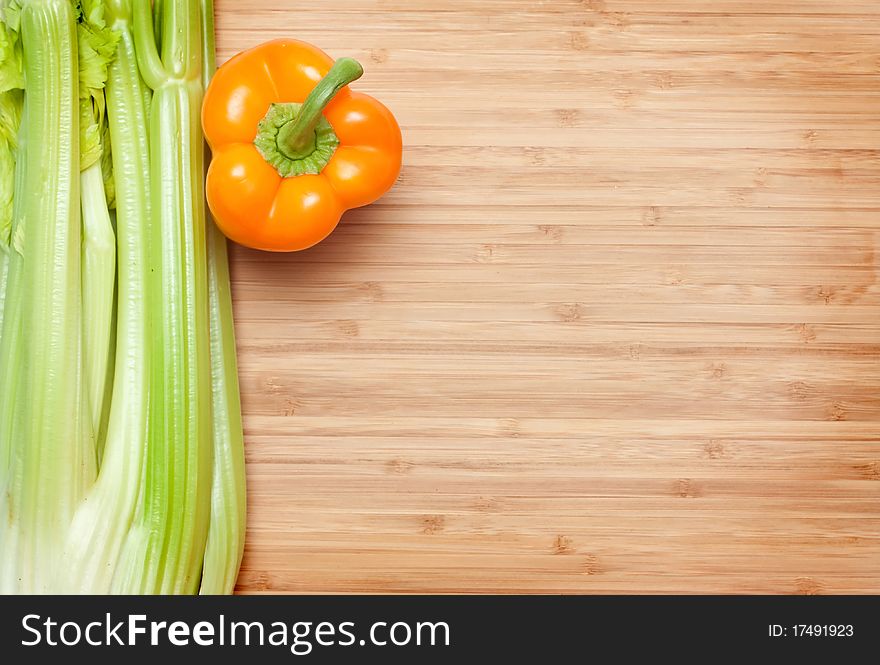 Orange pepper. green salad on cutting board. Orange pepper. green salad on cutting board