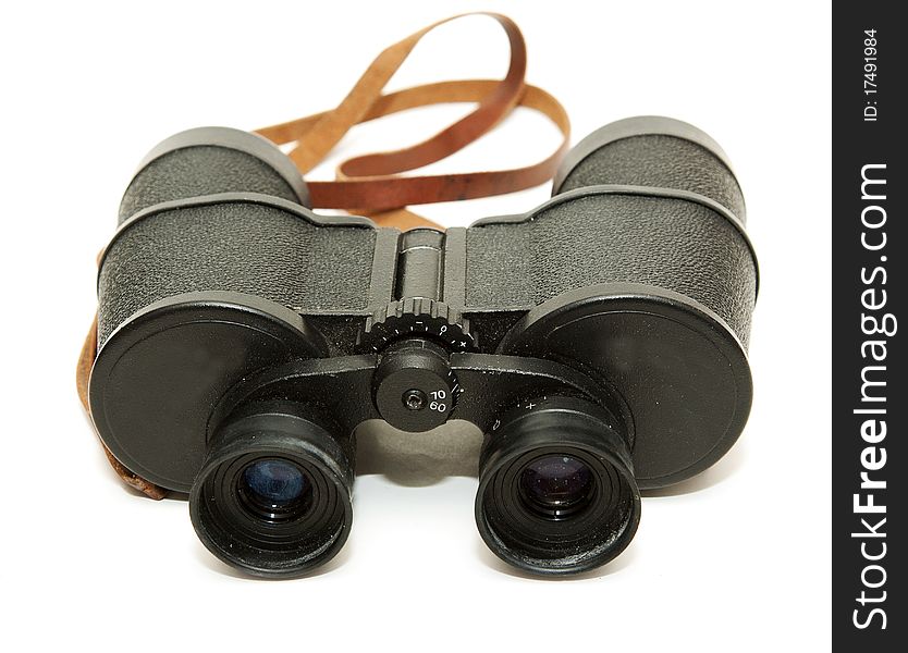 Old black glasses with a leather strap on a white background