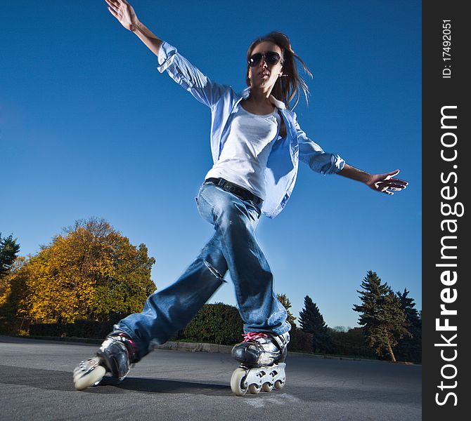 Wide-angle shot of a sliding rollerskater - motion blur on person. Wide-angle shot of a sliding rollerskater - motion blur on person