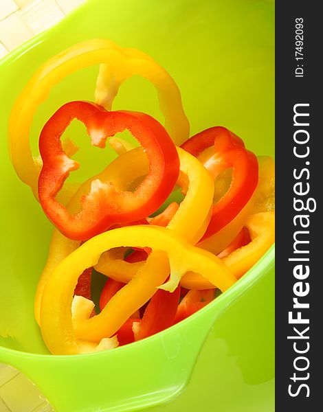 Image of sliced sweet peppers on bright green background