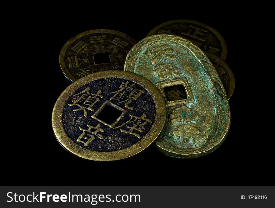 Old Chinese coins isolated on black background. Old Chinese coins isolated on black background.