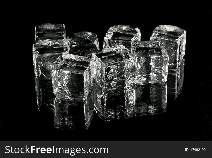 Glass cubes on black background with reflections.