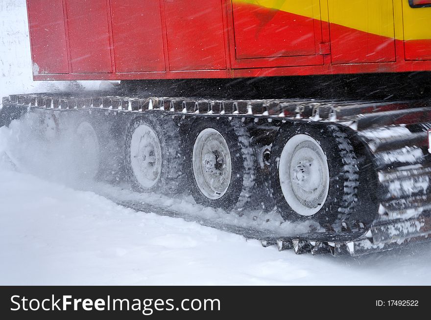 A marching tractor goes in the snowstorm. A marching tractor goes in the snowstorm