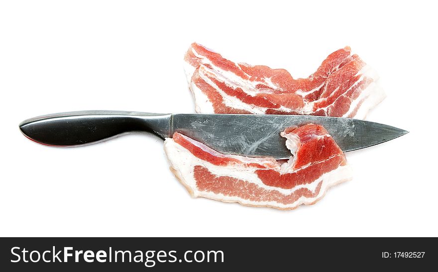 Chunks of raw meat with a steel knife on a white background