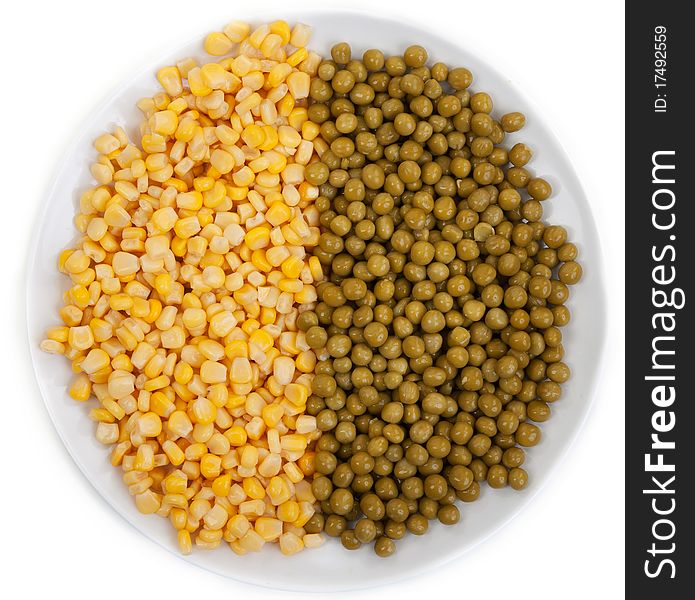 Corn and peas on a plate on a white background