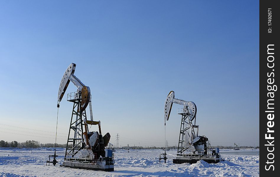 Cold winter, oil producing equipment is covered with snow. Cold winter, oil producing equipment is covered with snow