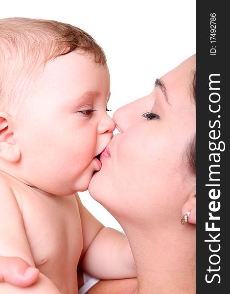 Happy young mother kissing a baby isolated on white