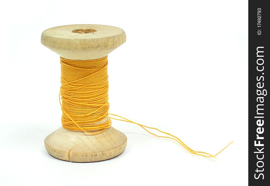 The spool of yellow threads
