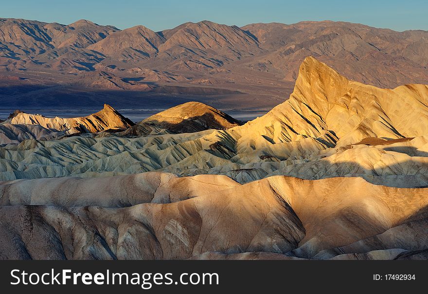 Zabriske badlands and Manly Beacon at sunrise from Zabriske Point in Death Valley National Park, California