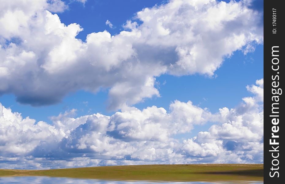 Lake on green meadow. Composition of nature.