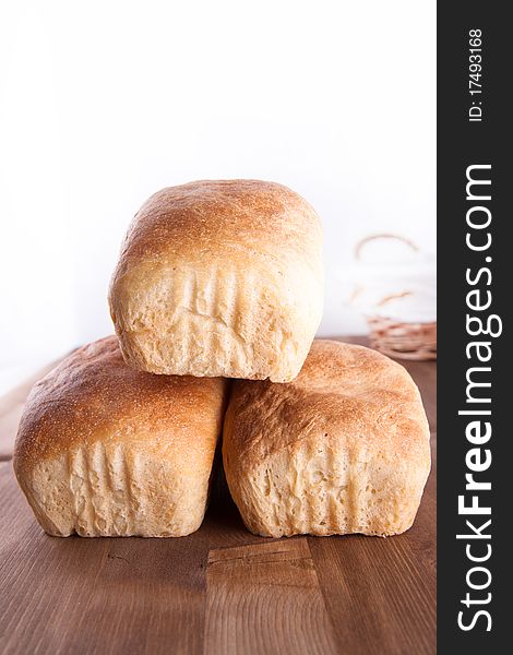 Three loaf of fresh cooking bread on the wooden desk. Three loaf of fresh cooking bread on the wooden desk