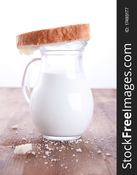 Fresh cooking bread with the jug of a milk. Fresh cooking bread with the jug of a milk