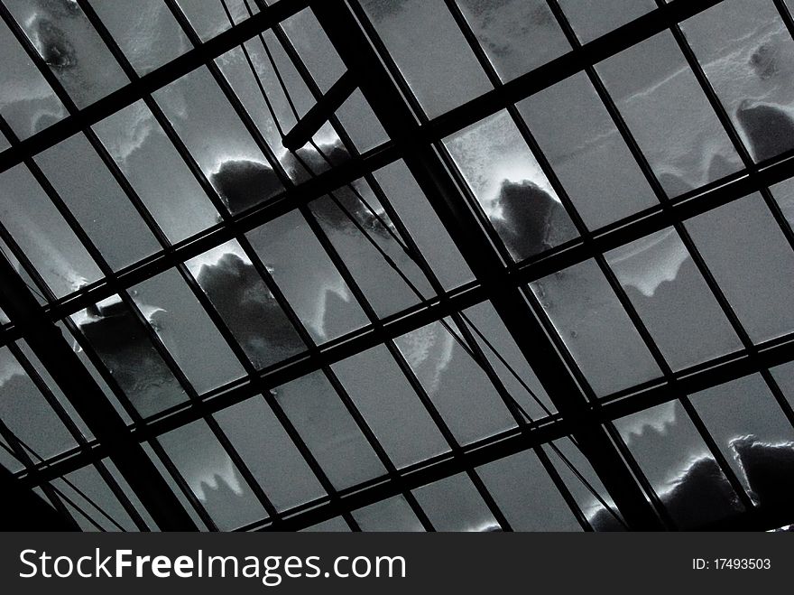 Snow covered glass roof shot from indoor. Snow covered glass roof shot from indoor