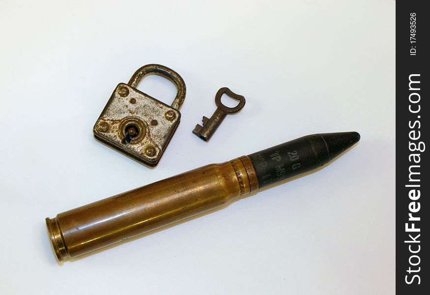 Antique lock with very large WWII bullet. Antique lock with very large WWII bullet