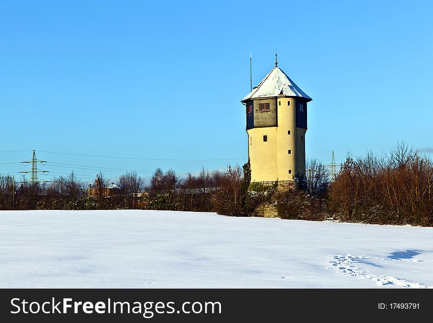 Watertower In  Snow Covered Fields