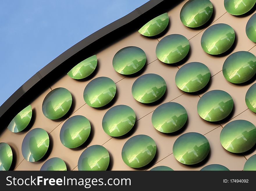 Green dots on the exterior wall of a building for a pattern