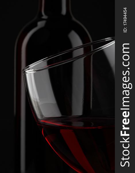 Half of red wine glass isolated on black background