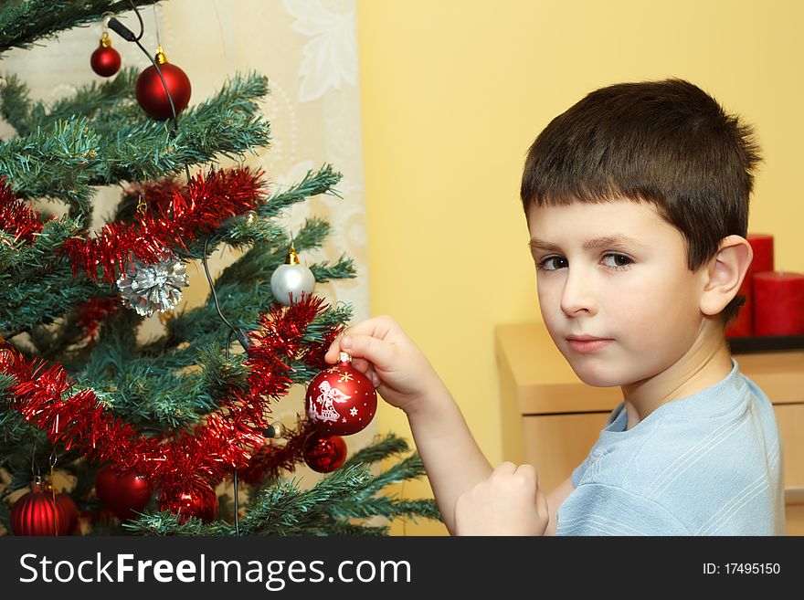 Young Boy Holding Christmas Decorations