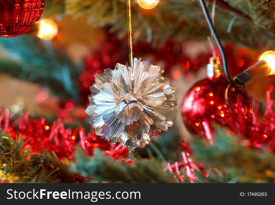 Closeup detail of Christmas decoration on tree with light