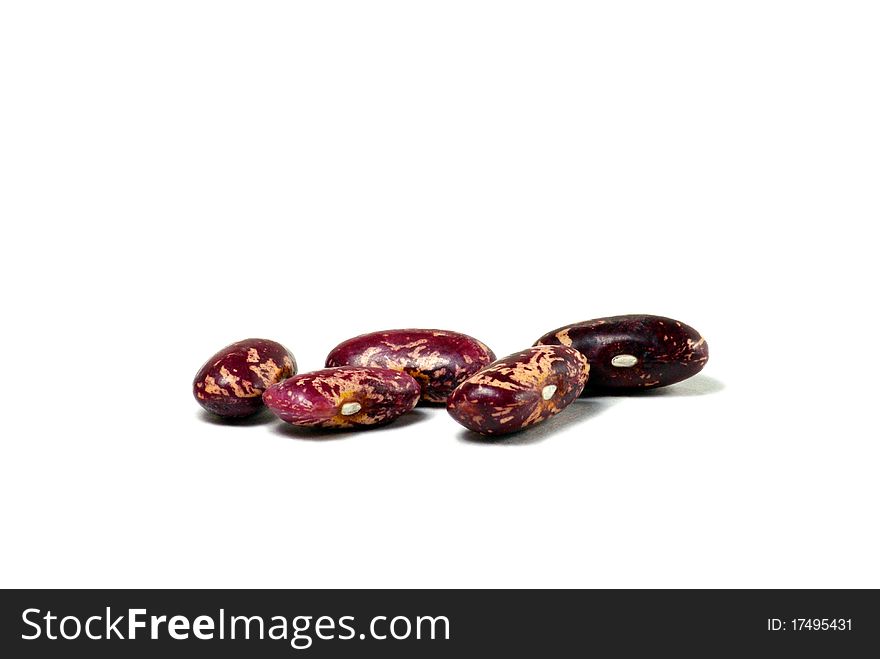 A close-up of several kidney beans against a white background