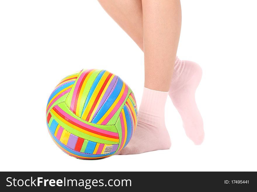 Close-up of human legs with a multicolored ball isolated on white