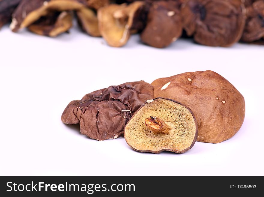A few dried mushrooms on a white background. A few dried mushrooms on a white background