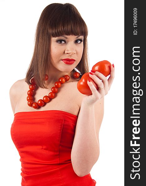 Fashion beautiful model dressed in the red dress stand with a tomato necklace and isolated on a white background. Fashion beautiful model dressed in the red dress stand with a tomato necklace and isolated on a white background