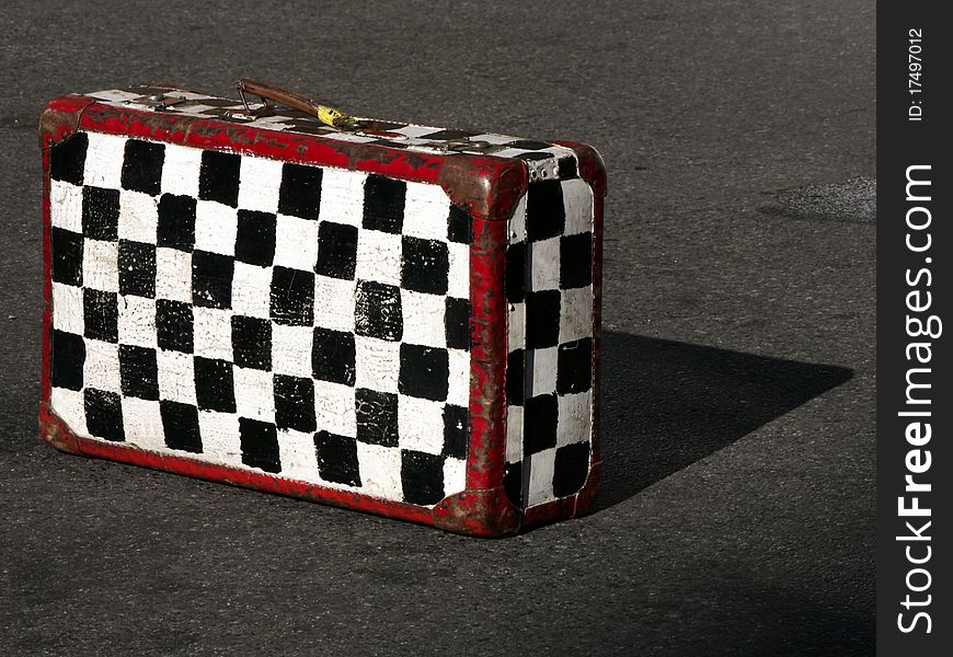 Plaid suitcase in the street