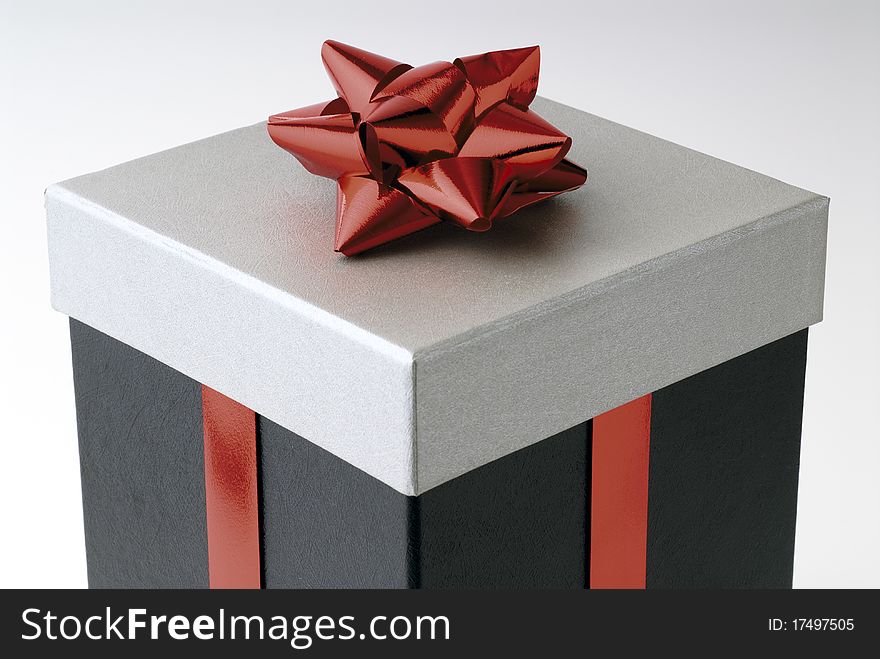 Gift in a box with red ribbon