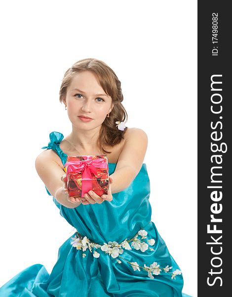 Young beautiful woman with a Christmas gift and flowers. Young beautiful woman with a Christmas gift and flowers.