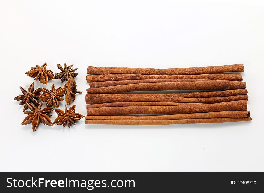 Star anise (Illicium verum) and cinnamon (Cinnamomum verum) sticks on white background. Star anise (Illicium verum) and cinnamon (Cinnamomum verum) sticks on white background.