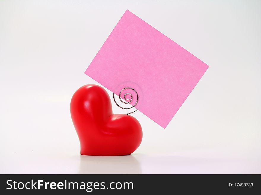 Plump heart with pink placecard; copyspace. Plump heart with pink placecard; copyspace