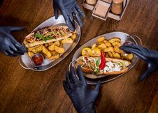 Two Hungry Young Men Eating A Hot Dogs In Cafe. Restaurant Royalty Free Stock Images