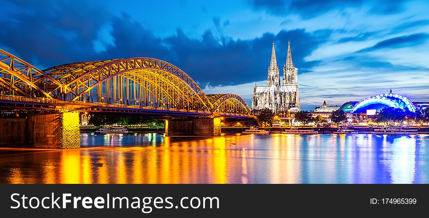 Cologne at night with illuminated Cologne Cathedral, Hohenzollern Bridge and Rhine River. Cologne at night with illuminated Cologne Cathedral, Hohenzollern Bridge and Rhine River
