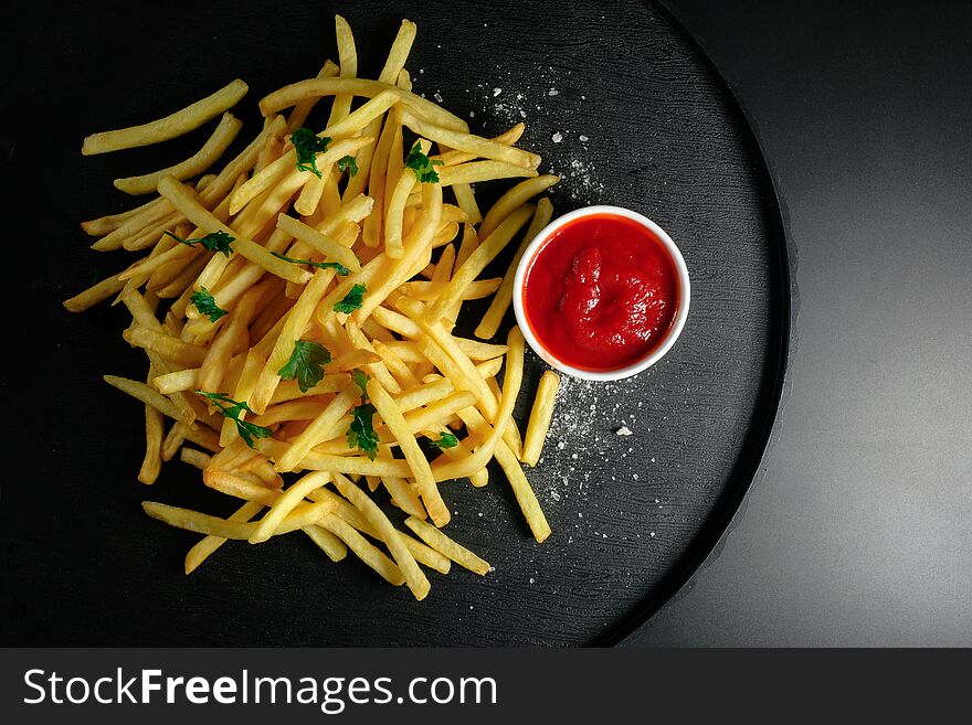 Chips Fries And Ketchup On A Dark Background. Top View, Unhealthy Food