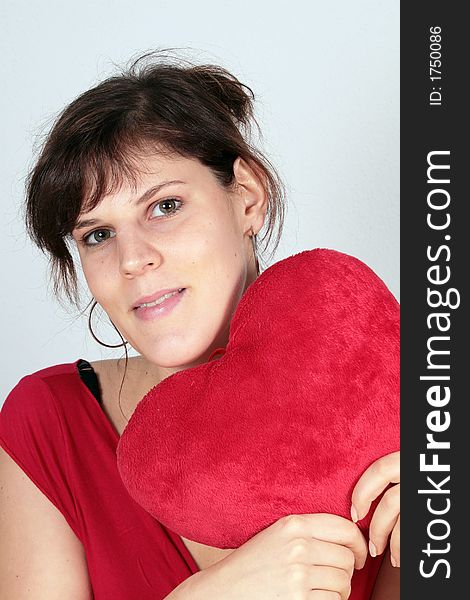A young beautiful woman with her valentine's plush heart!. A young beautiful woman with her valentine's plush heart!