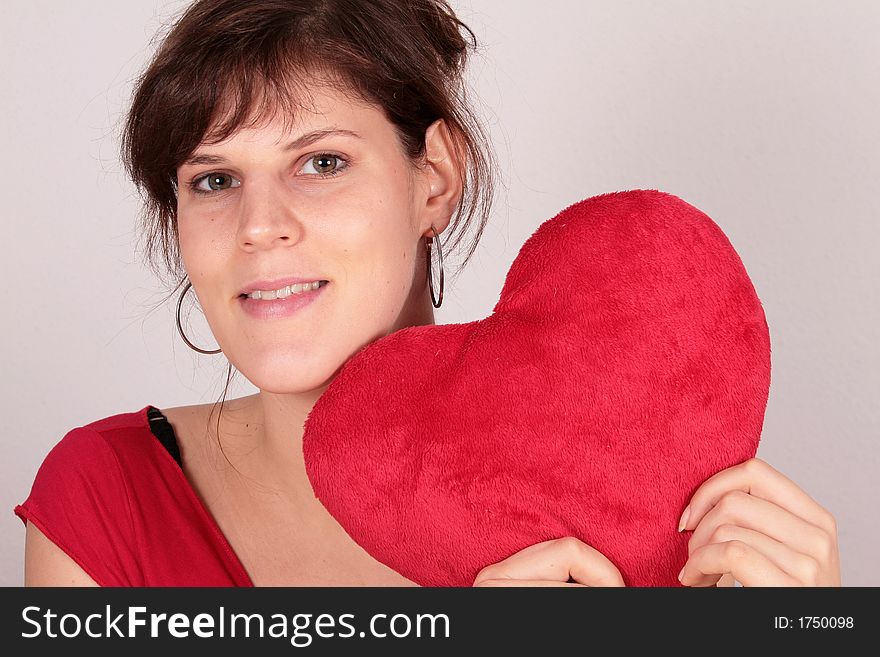 A young beautiful woman with her valentine's plush heart!. A young beautiful woman with her valentine's plush heart!