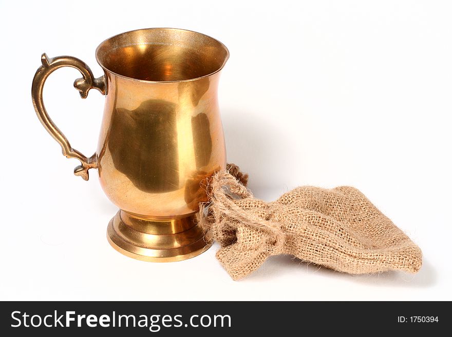 A brass cup and hessian bag. A brass cup and hessian bag.