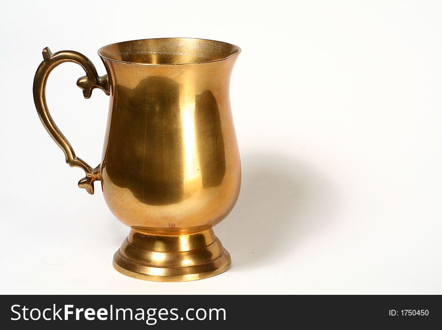 A brass cup on white background. A brass cup on white background.