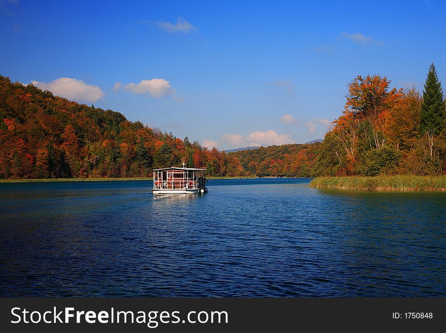 Autumn mountain lake with boat