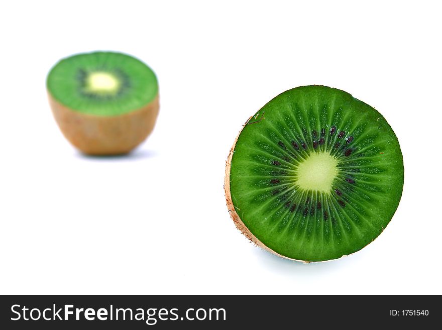 Close-up of slices of green kiwi fruit with seeds inside