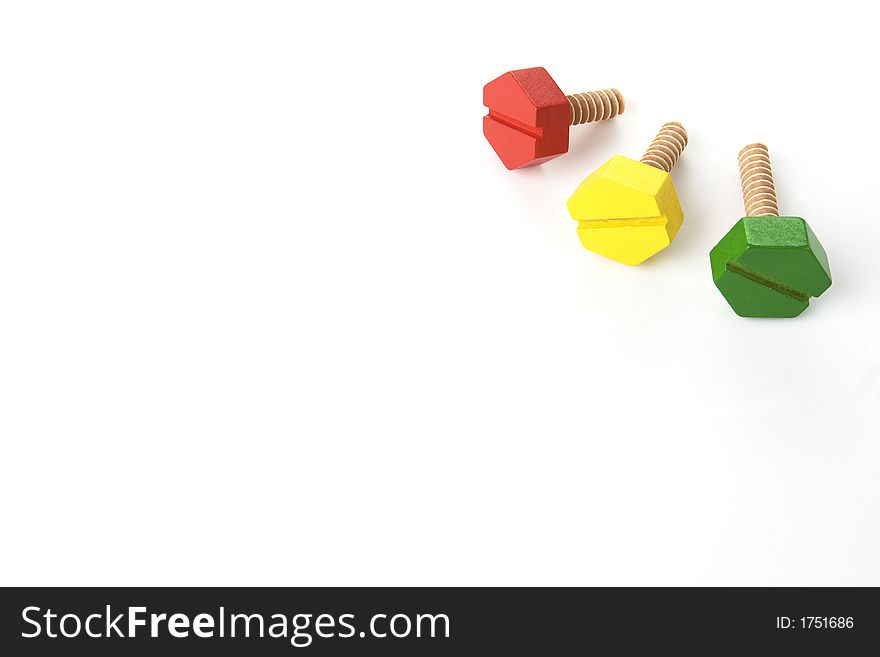 Red, green and yellow toy wooden screws